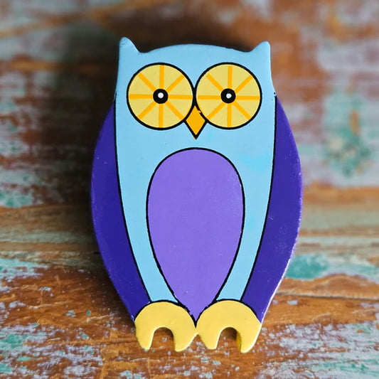 A blue and purple Magnetic Wooden Owl Play Figure on a wooden surface.