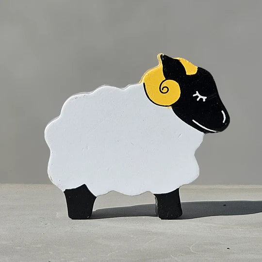 A Magnetic Wooden Sheep Play Figure with black and yellow horns.