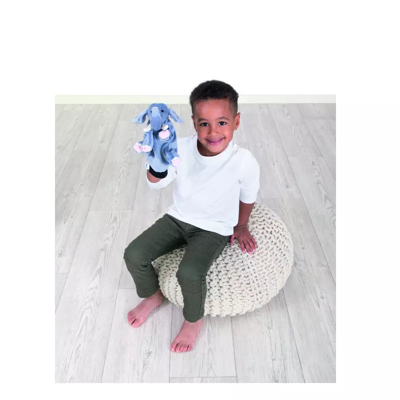 A young boy captivatingly performs a puppet show with the Beleduc Hand Puppet Elephant, entertaining kids with his delightful act.