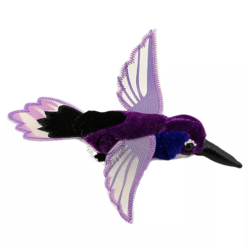 A purple and black Hummingbird Finger Puppet flying in a puppet show.