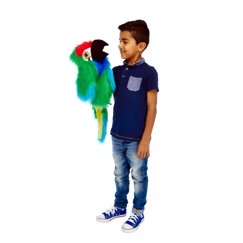 A young boy performing a puppet show with The Puppet Company Large Bird Military Macaw.