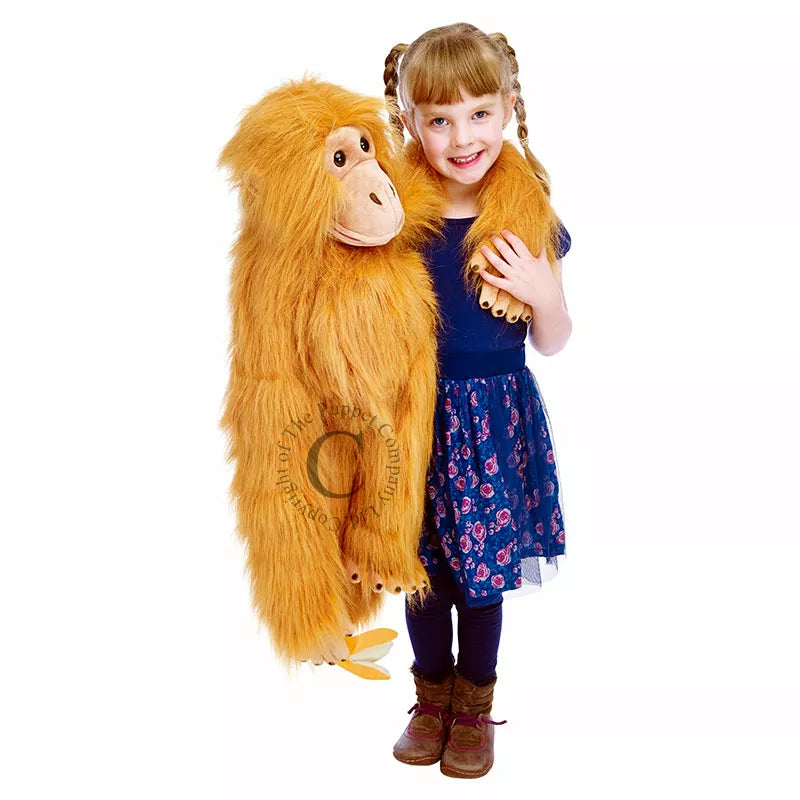 A little girl captivatingly performs a puppet show with The Puppet Company Large Puppet Orangutan.