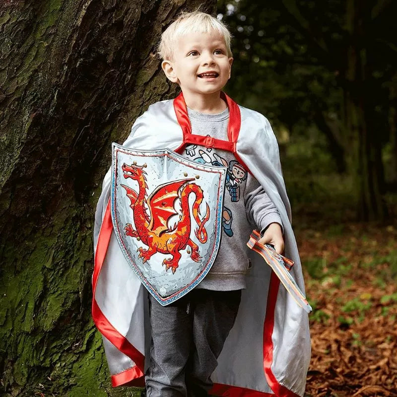 A young boy in a Liontouch Amber Dragon Knight Cape pretending to be a puppet in the woods during a kids' puppet show.