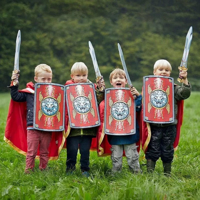 Four kids dressed as Romans performing a puppet show with Liontouch Roman Swords in a field.