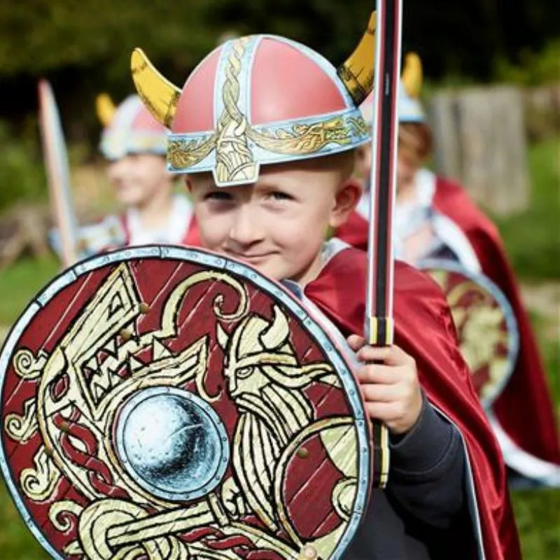 A group of children dressed as vikings holding Liontouch Viking Shields.