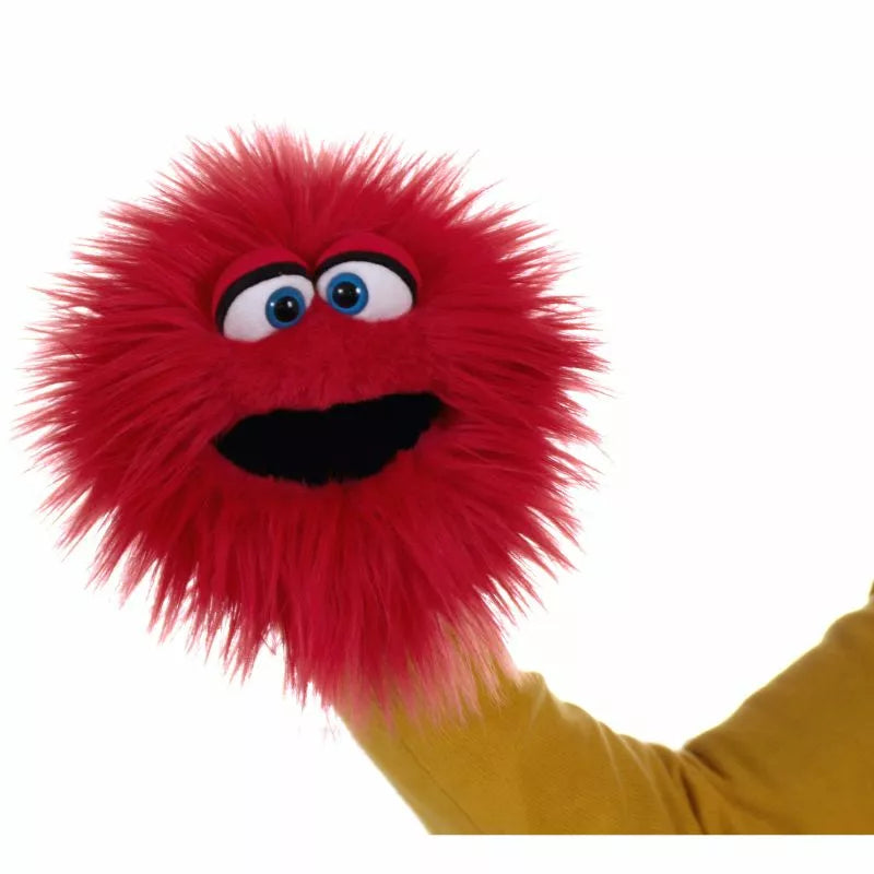 A person is holding a red and furry Living Puppets Twaddle Hand Puppet for a kids' puppet show.