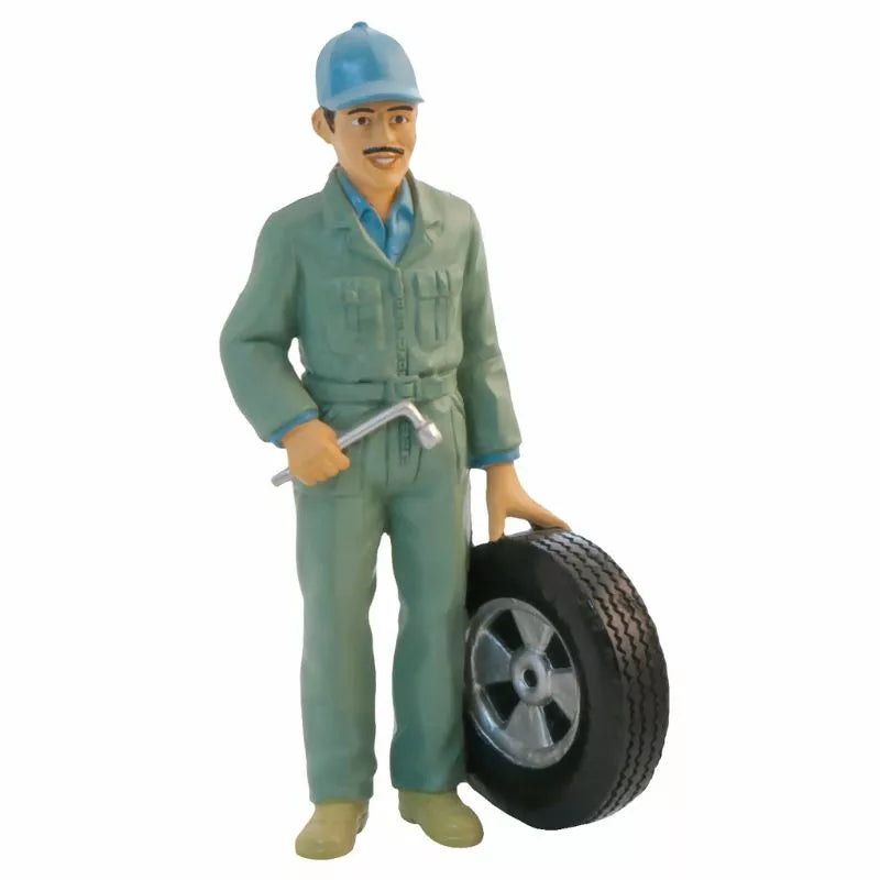 A puppet mechanic holding a tire in a Miniland Figures profession display for kids.
