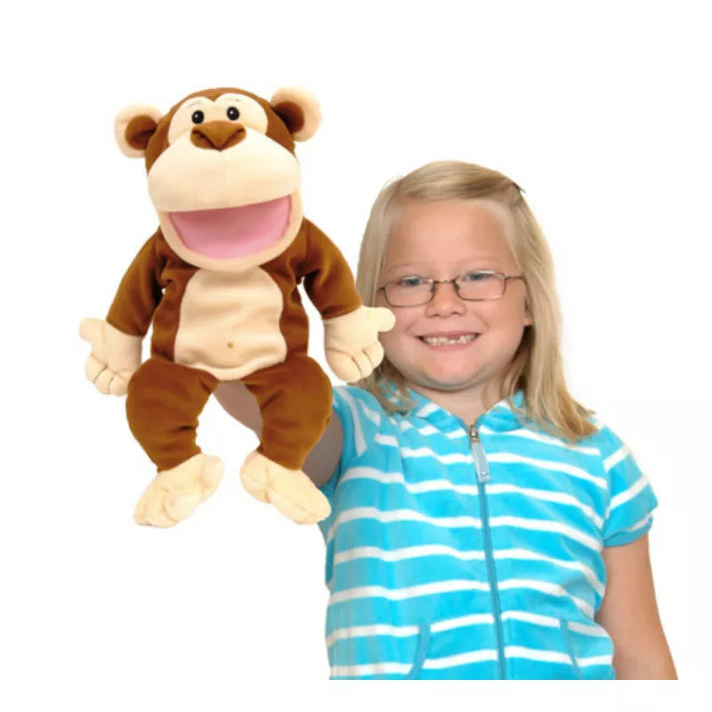 A little girl is showcasing a puppet show with a Fiesta Crafts Monkey Hand Puppet for kids to enjoy.