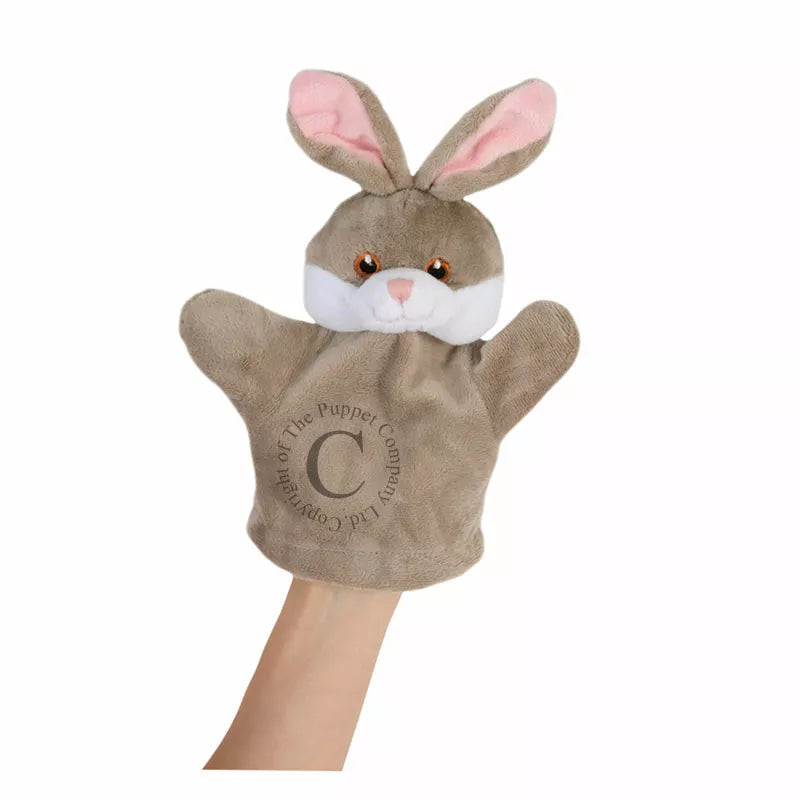 A children's puppet show featuring a hand holding The Puppet Company My First Puppet Rabbit with the letter c on it.